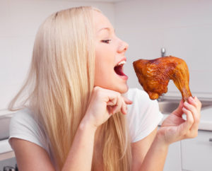 woman eating chicken