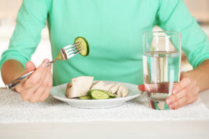 Girl and dietary food at table close-up