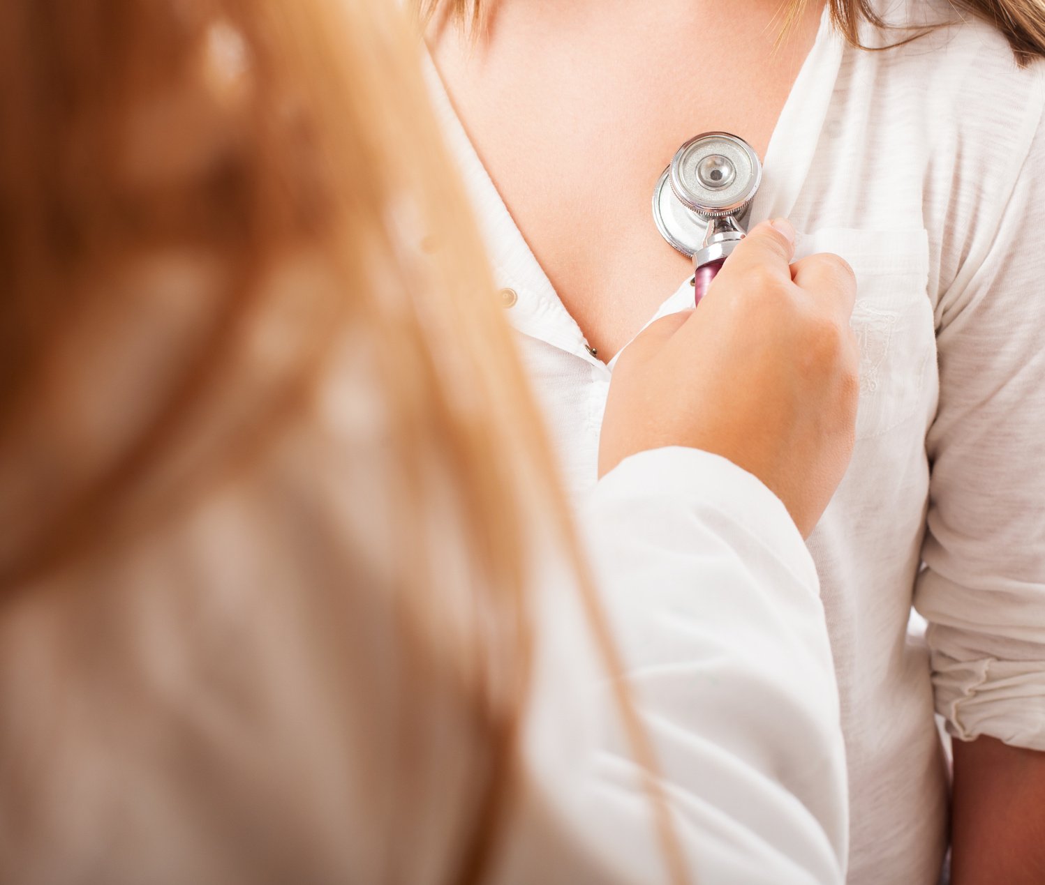 a doctor checking the heartrate of a girl