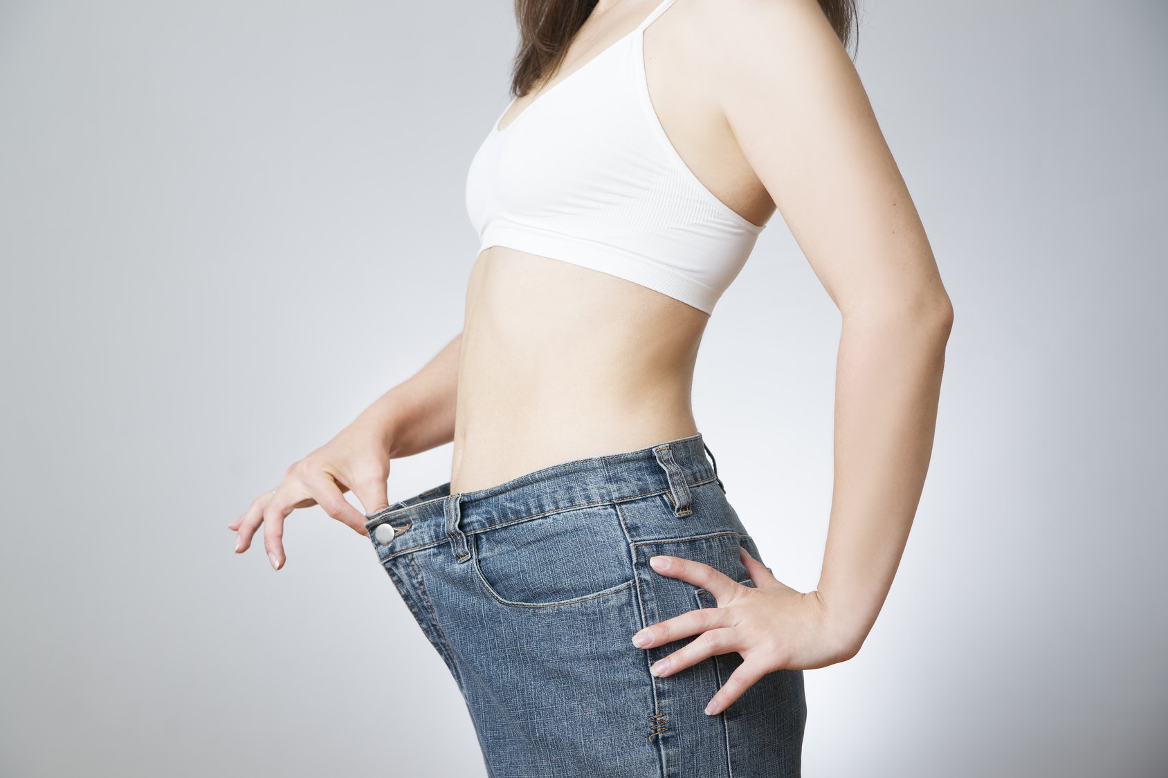 Young woman in jeans of large size, concept of weight loss