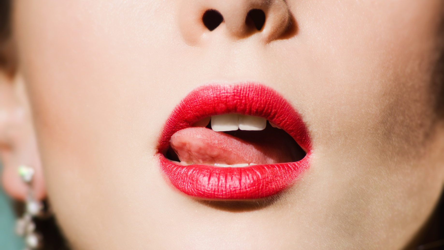 tip of tongue licks lips