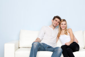 Young beautiful couple on a sofa at home