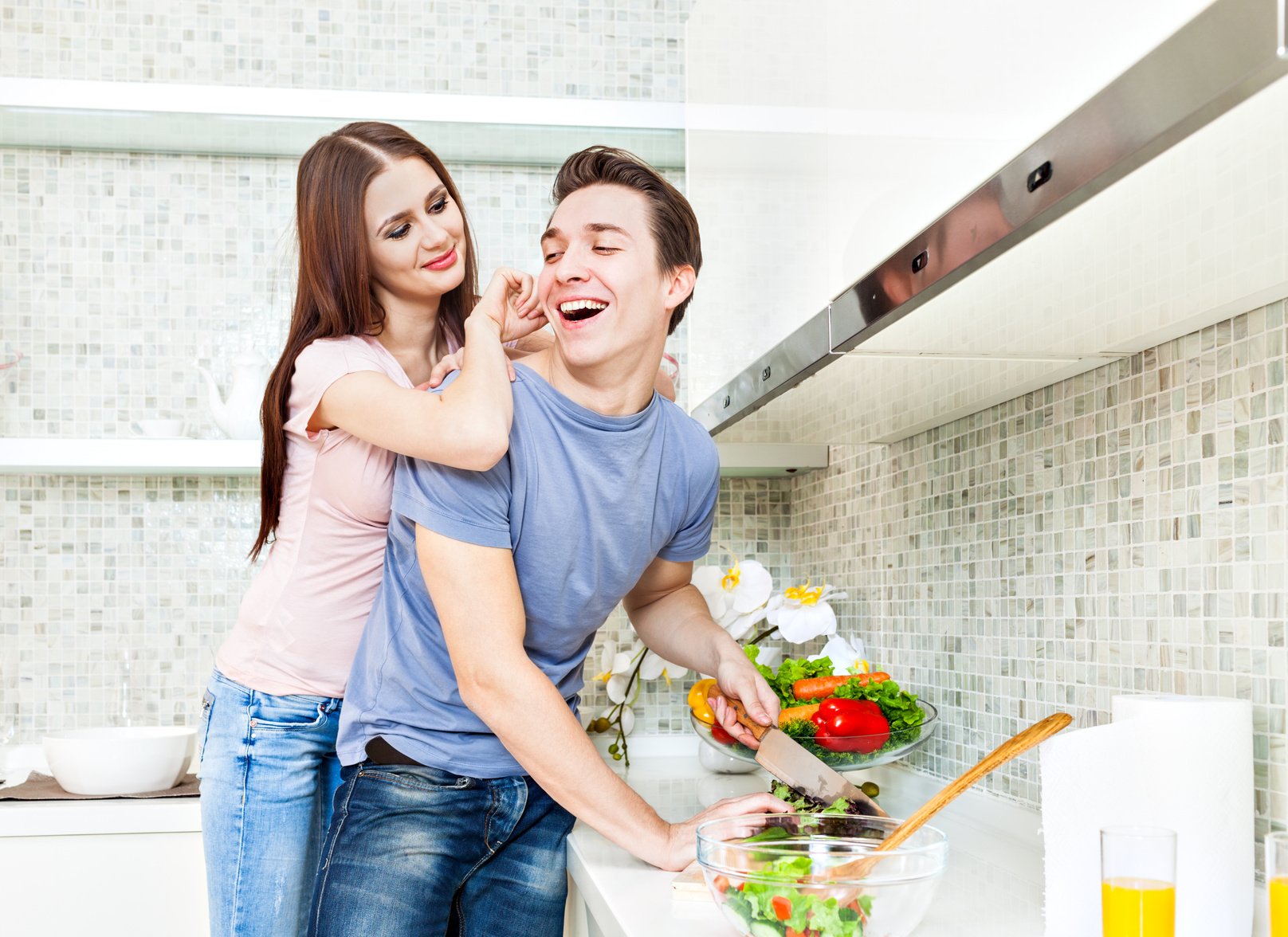 Husband and wife preparing food in the kitchen