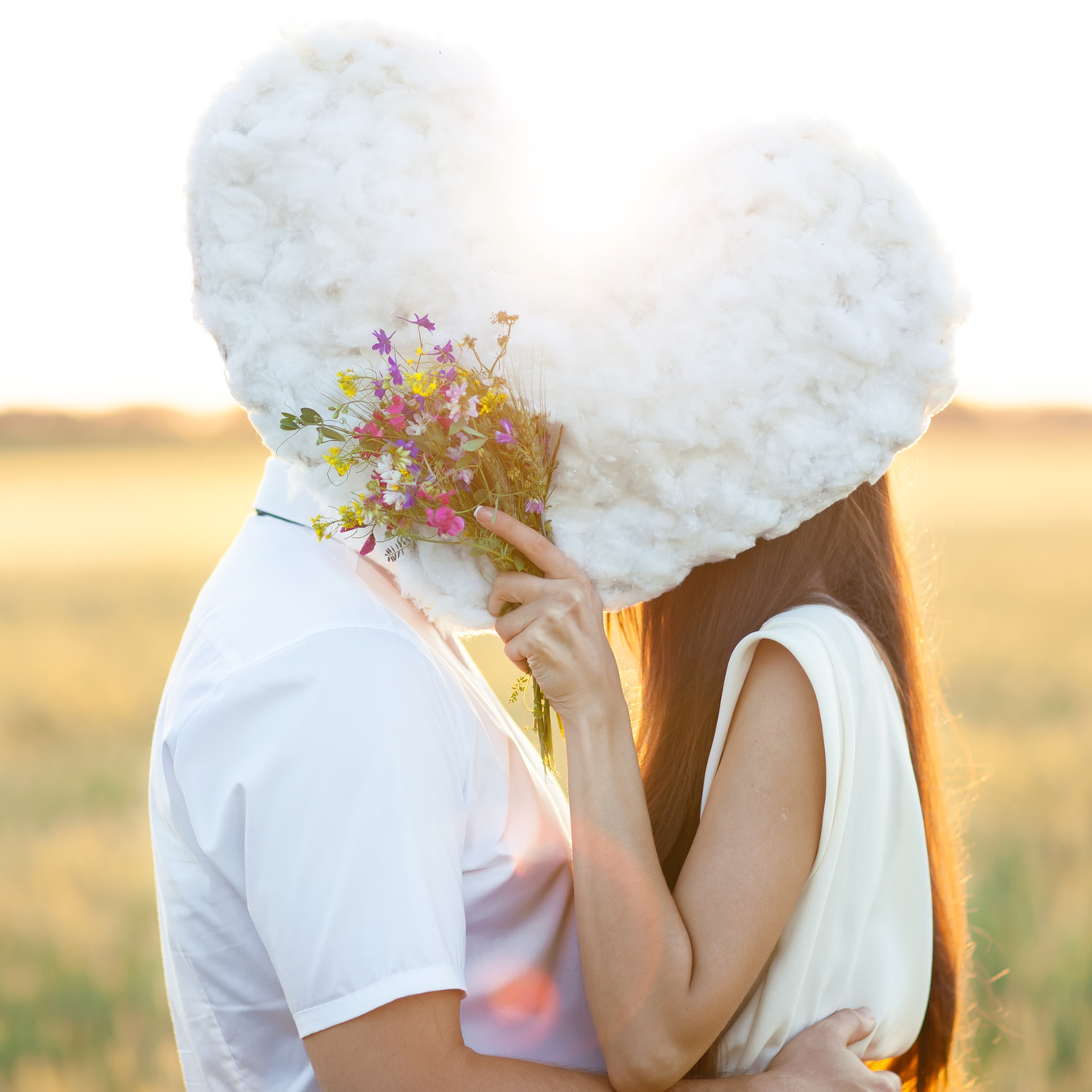 Young couple kissing behind