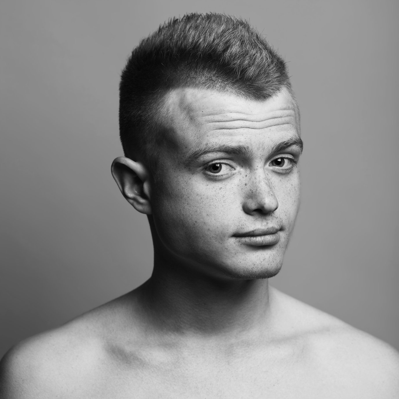 Male beauty concept. Fashionable young man with stylish haircut