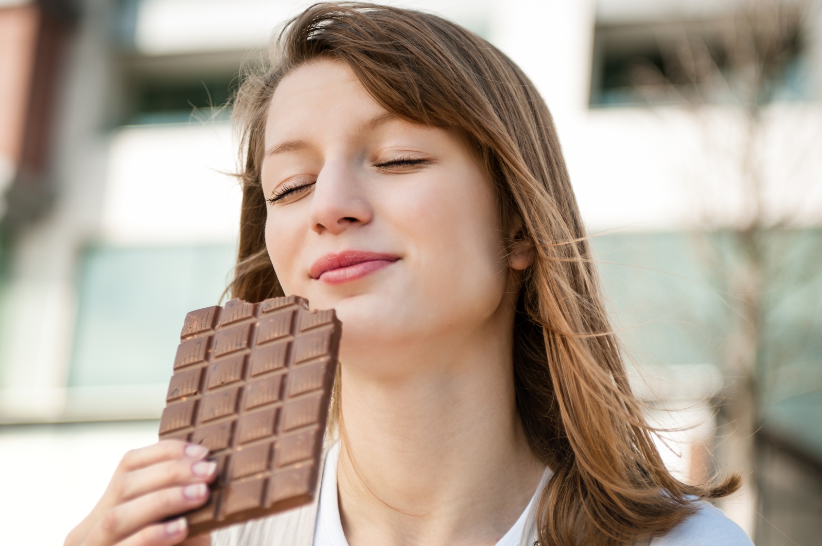 Young woman eating chocolate