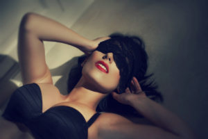 Young sexy woman with lace veil on eyes vintage style