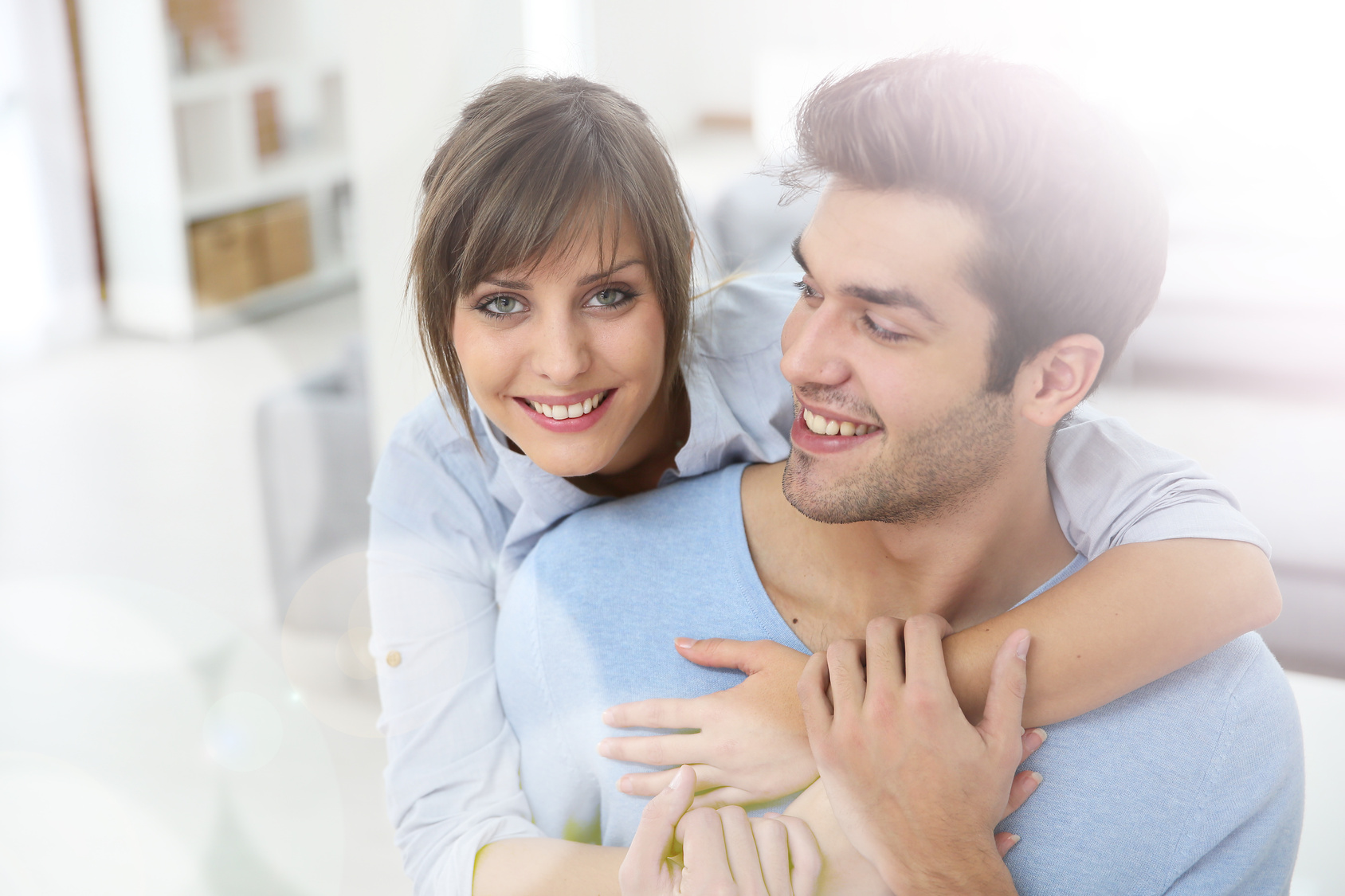 Happy young couple moving together in new apartment