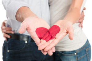 Red Heart Painted On Couple’s Hand