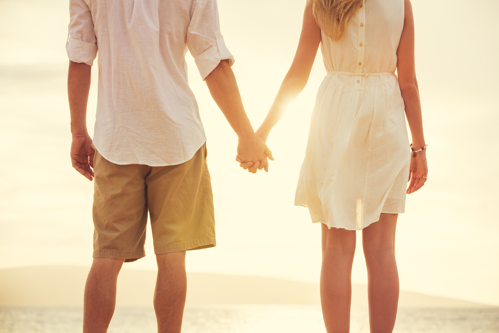 Young couple in love on the beach sunset