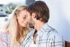 Attractive couple sitting on bench