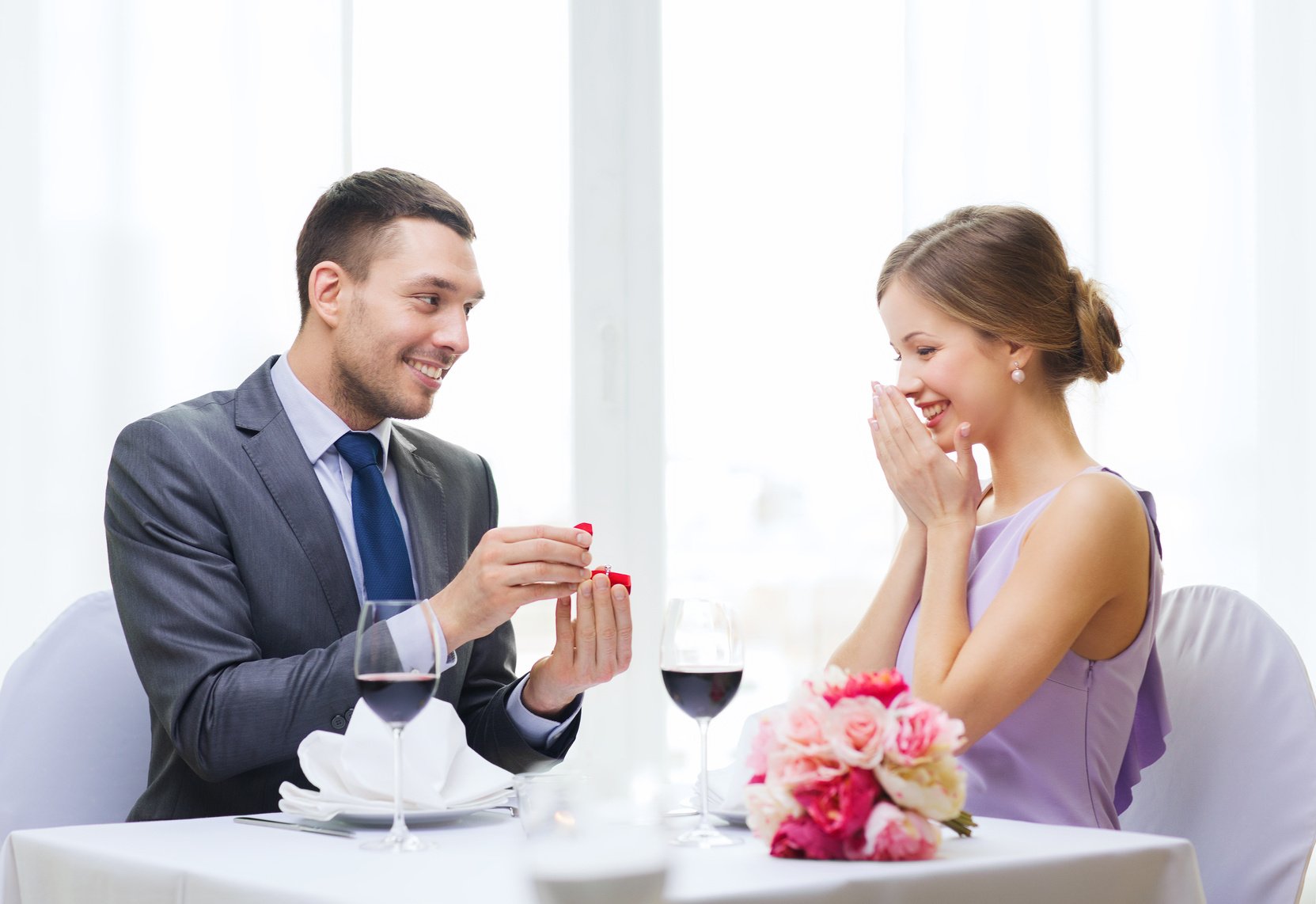 man proposing to his girlfriend at restaurant