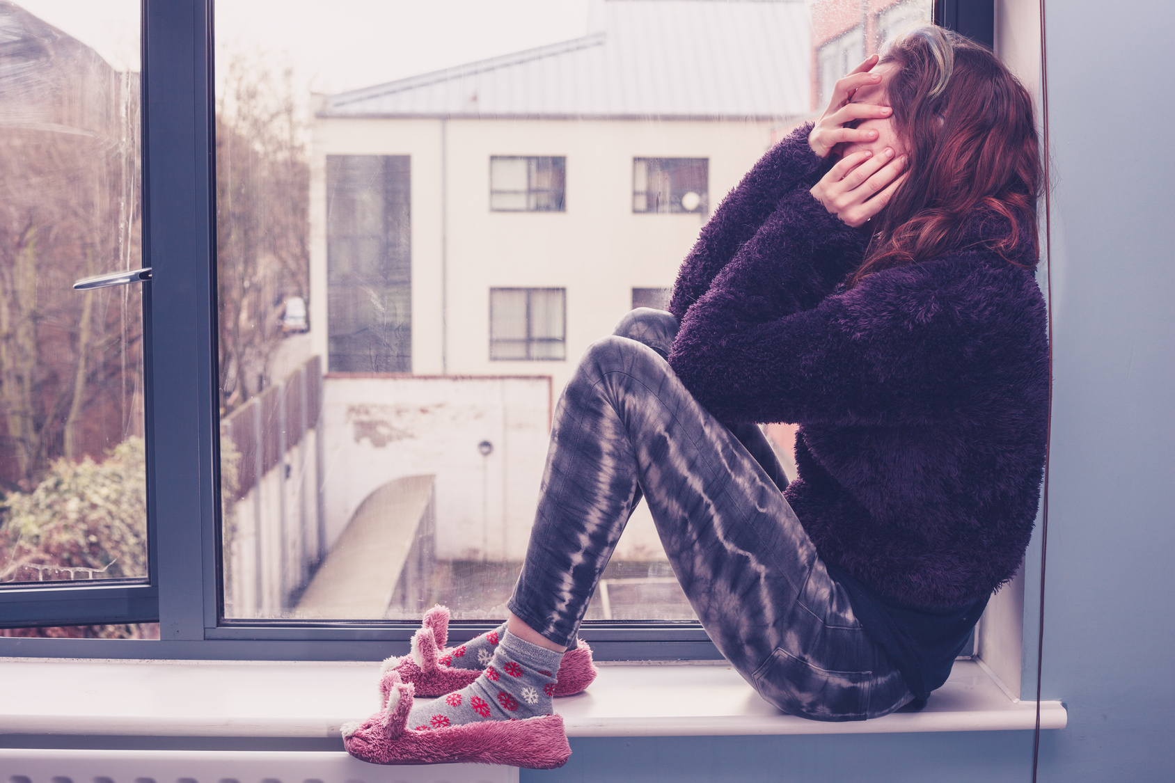 Sad woman by the window