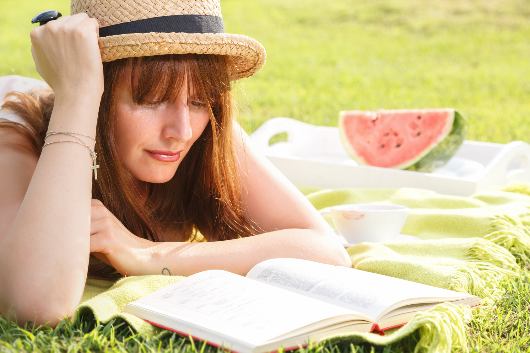 Young woman reading book in the park