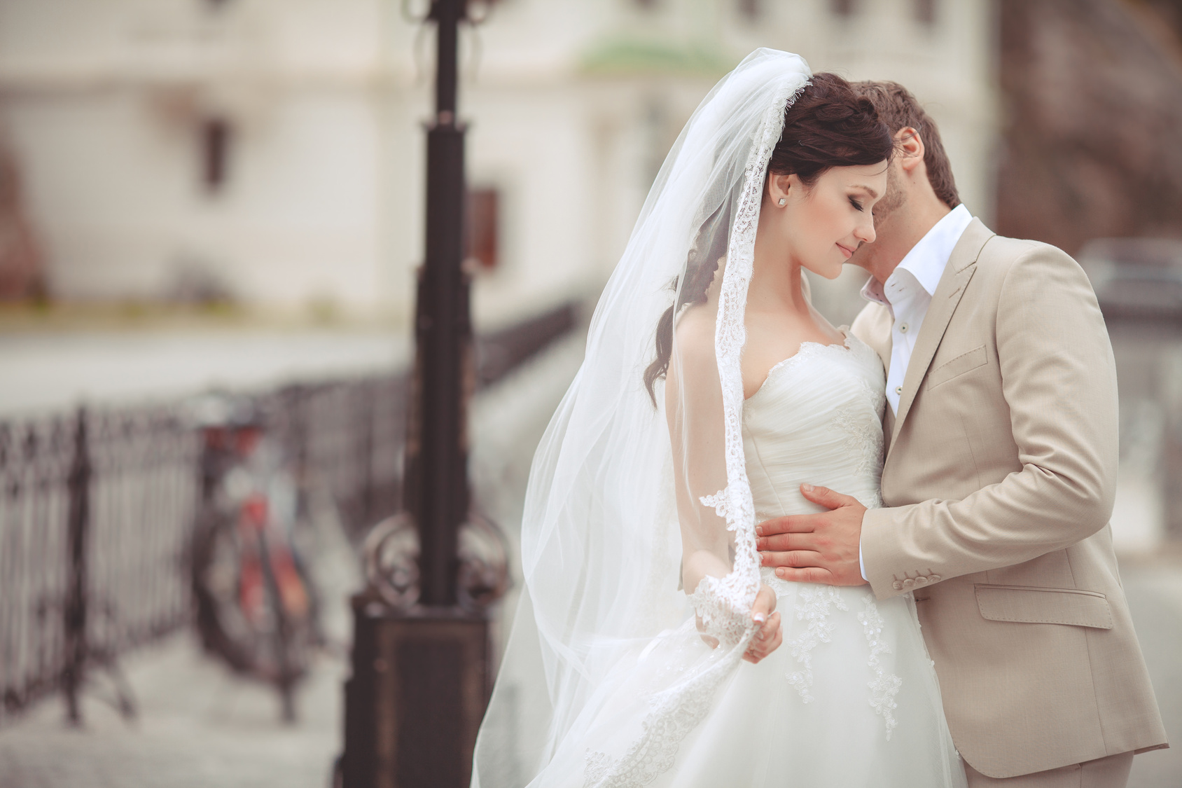 Bride and groom at wedding day kissing at park