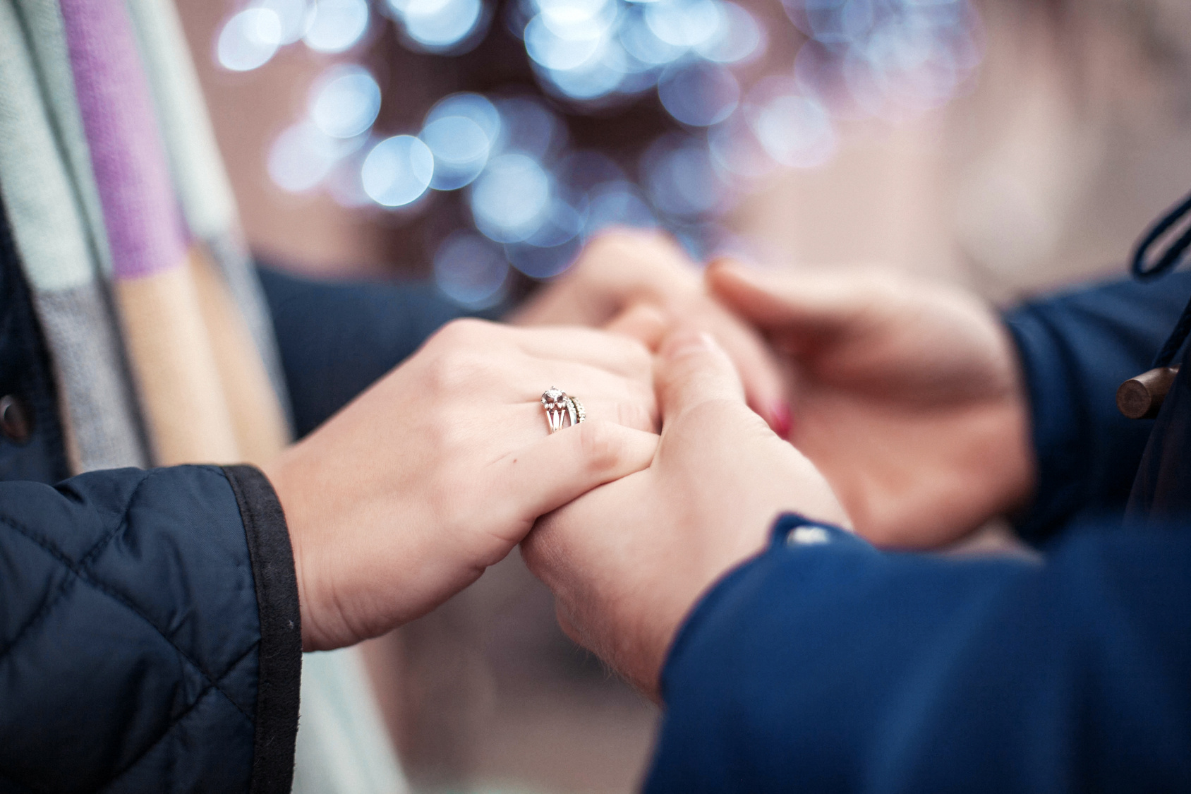 Close-up image of a young couple holding hands