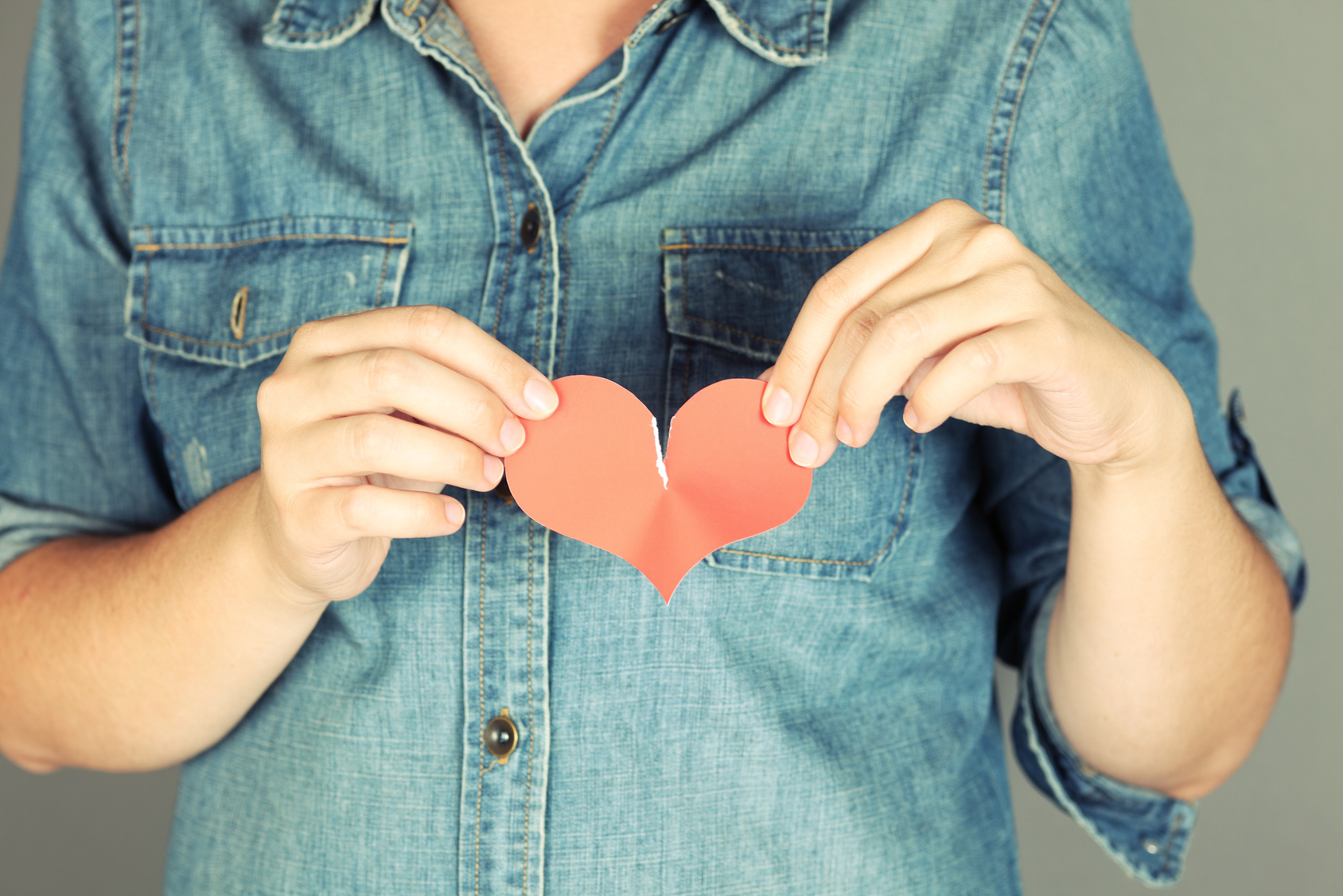 Torn heart in women hands