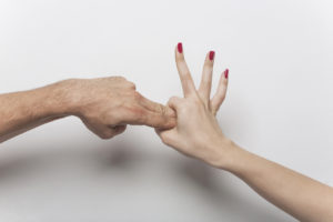 Couple hands making sex gesture 2