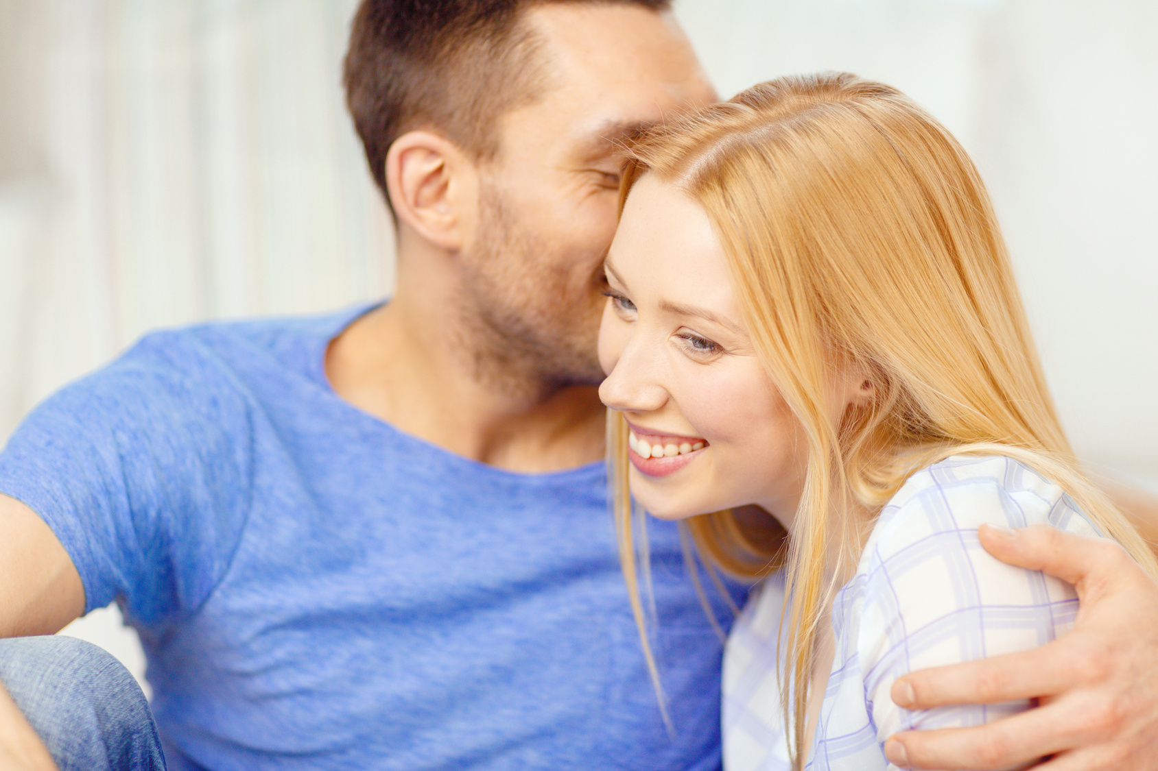 smiling happy couple at home