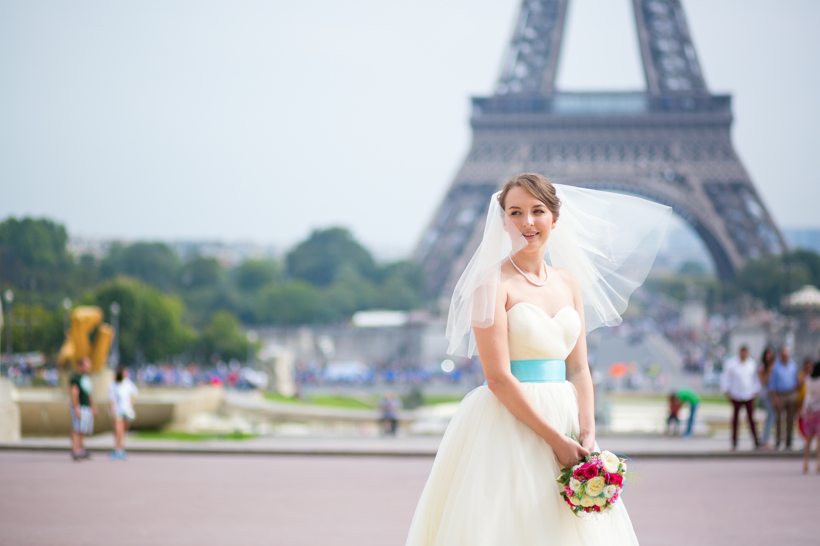 Happy young beautiful bride in Paris