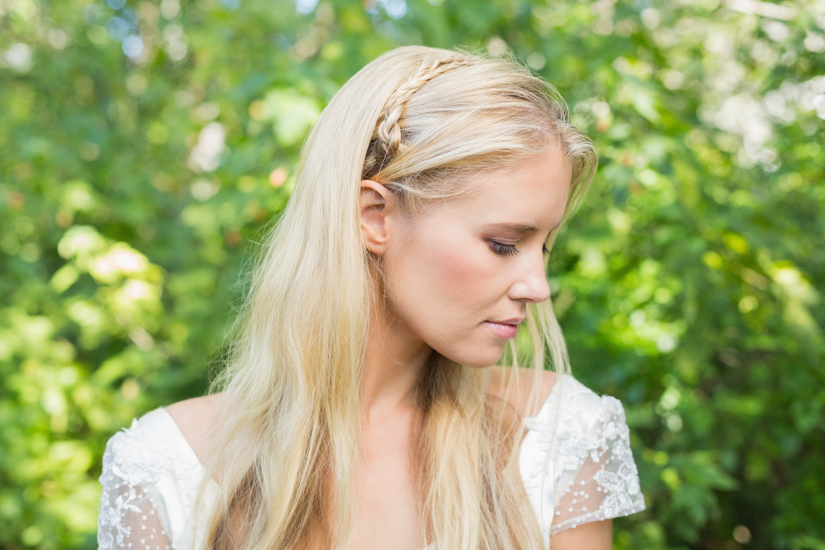 Blonde bride looking peaceful in the countryside