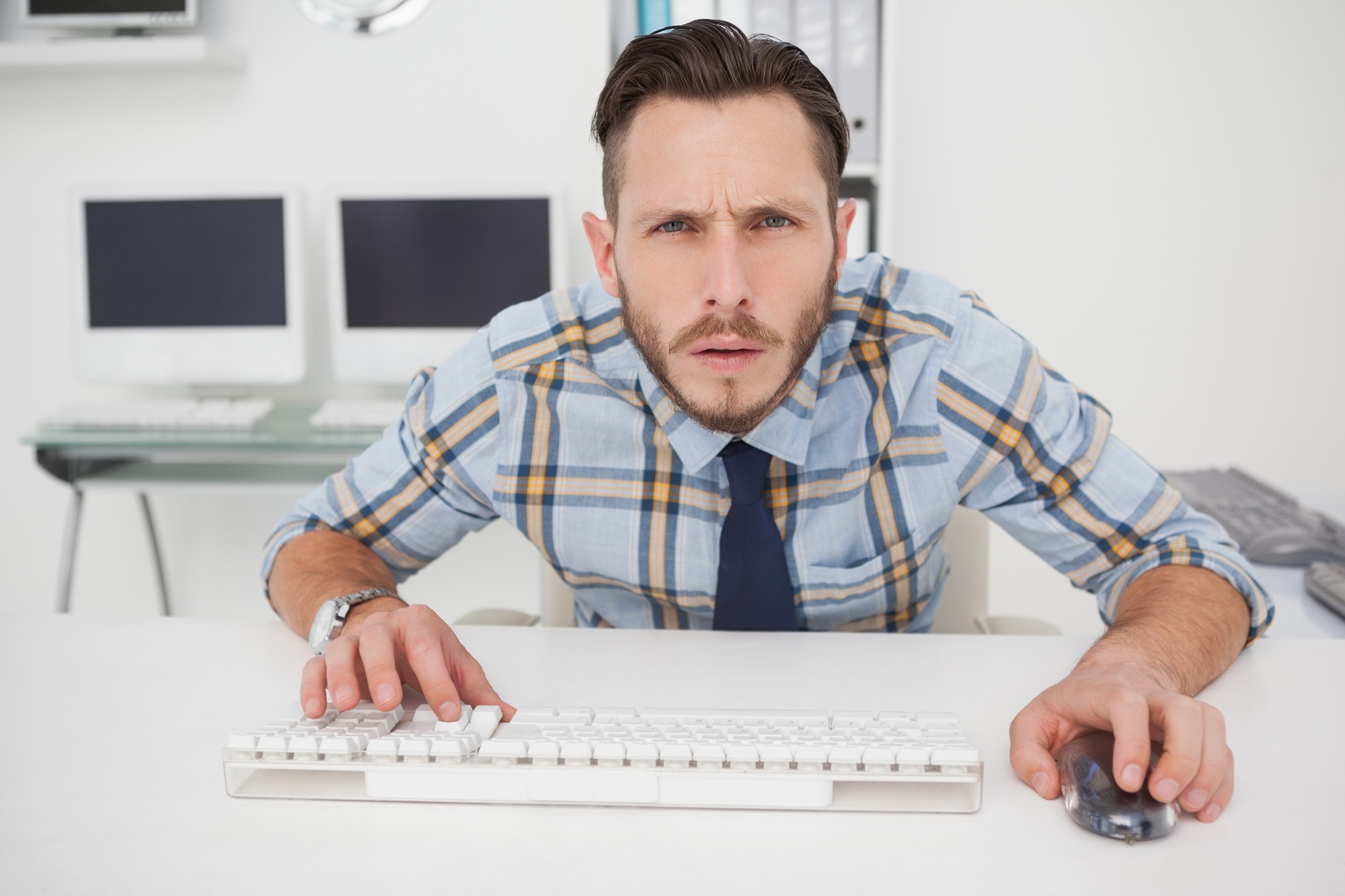 Focused casual businessman working at his desk