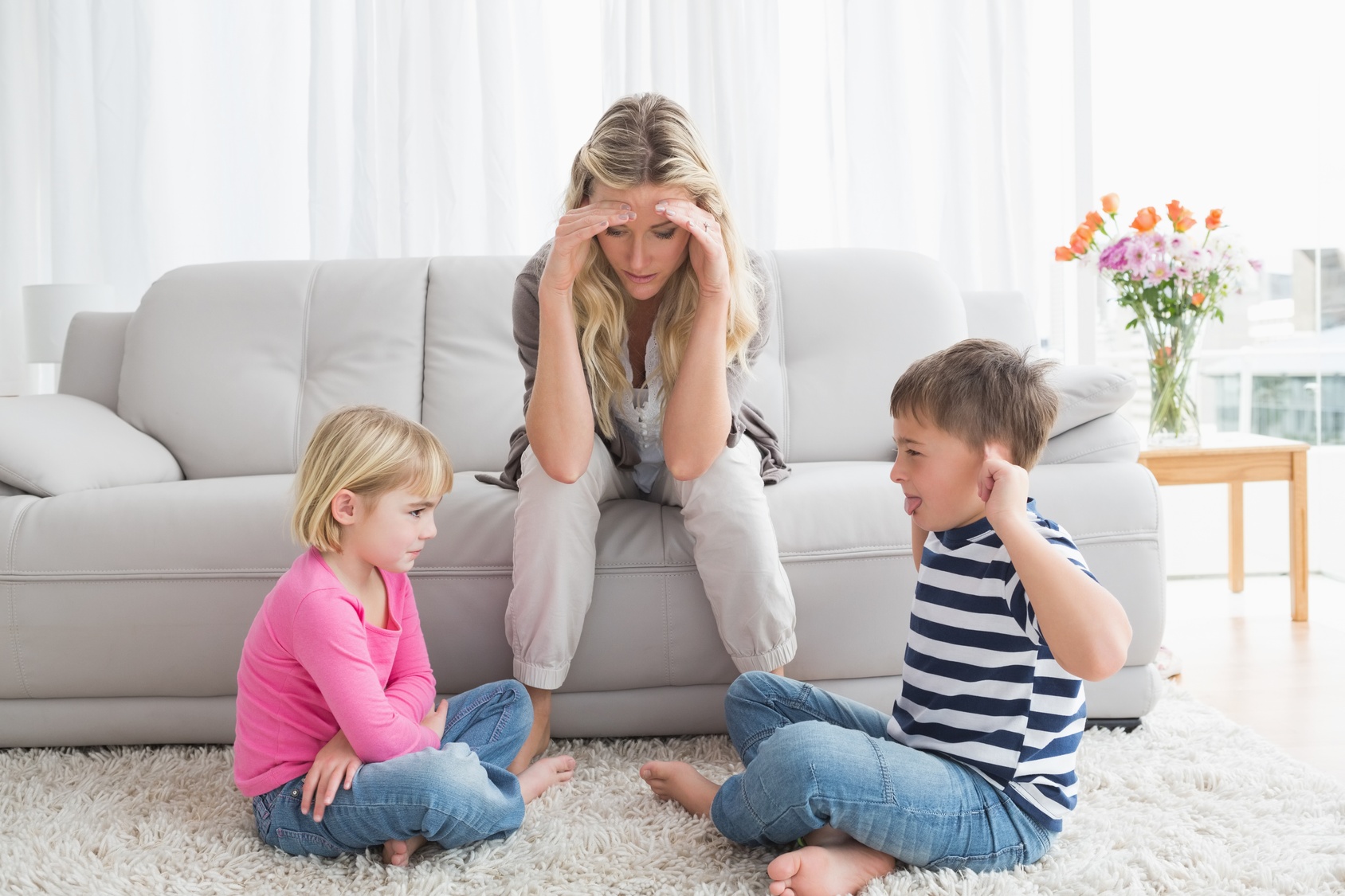 Fed up mother listening to her young children fight