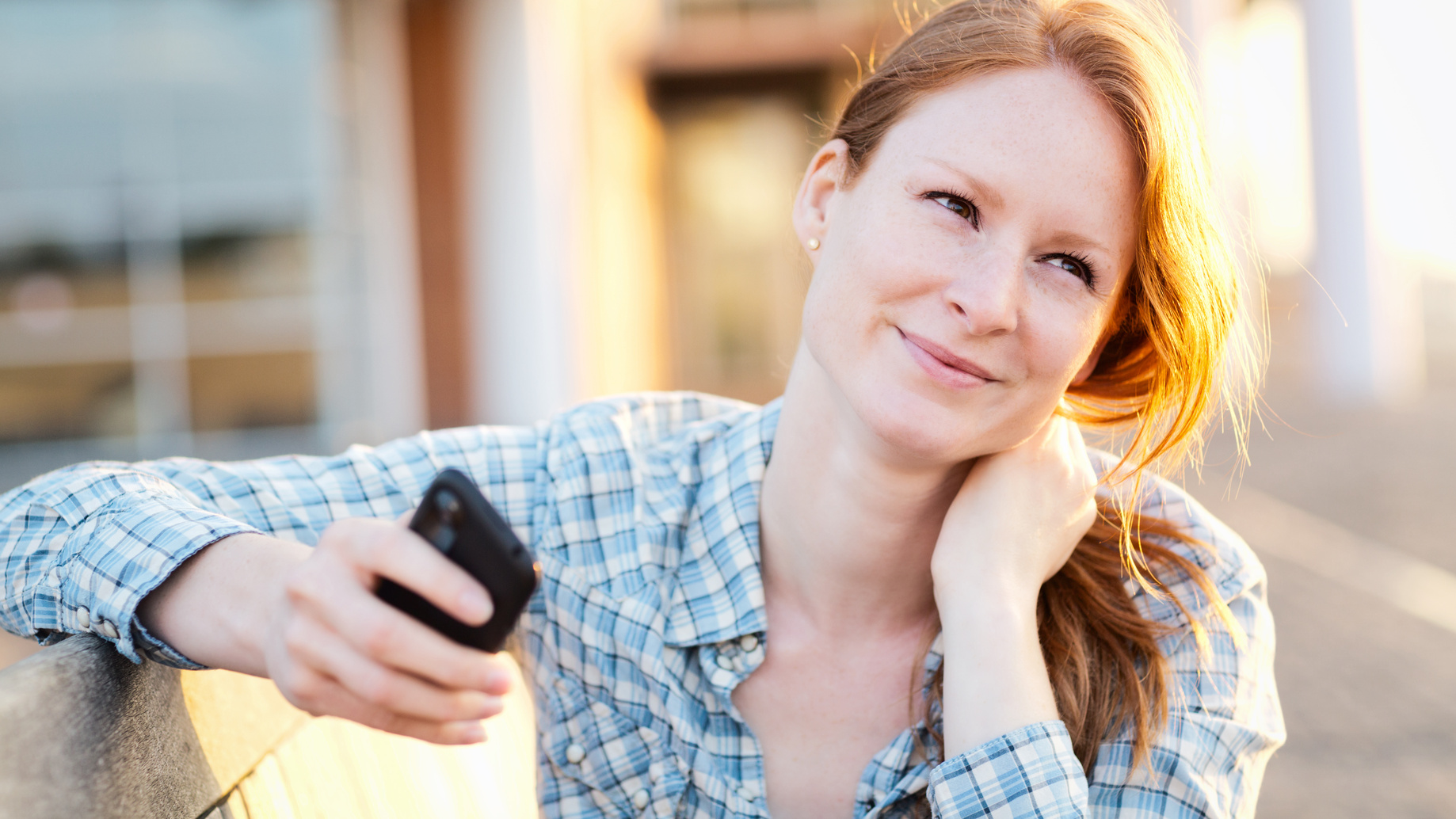 Woman with a Smartphone in a City