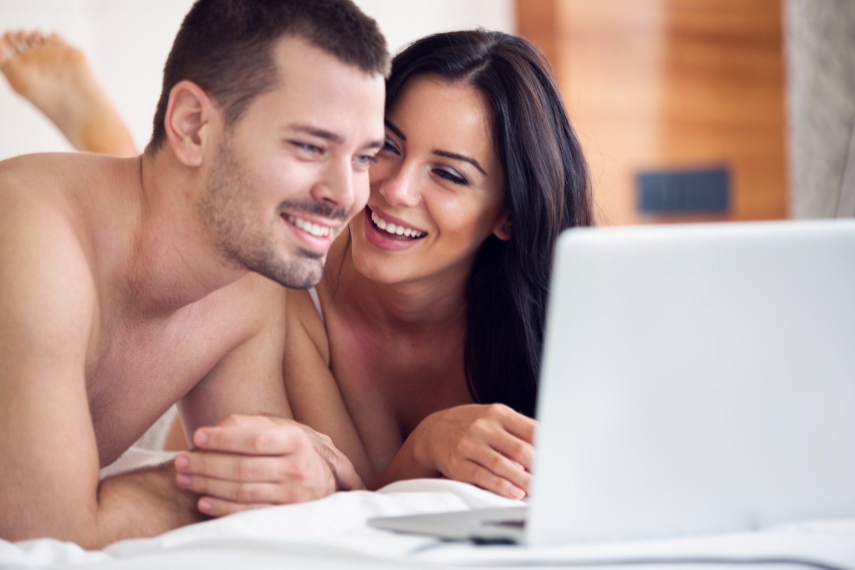 Lovers watching a movie on their laptop