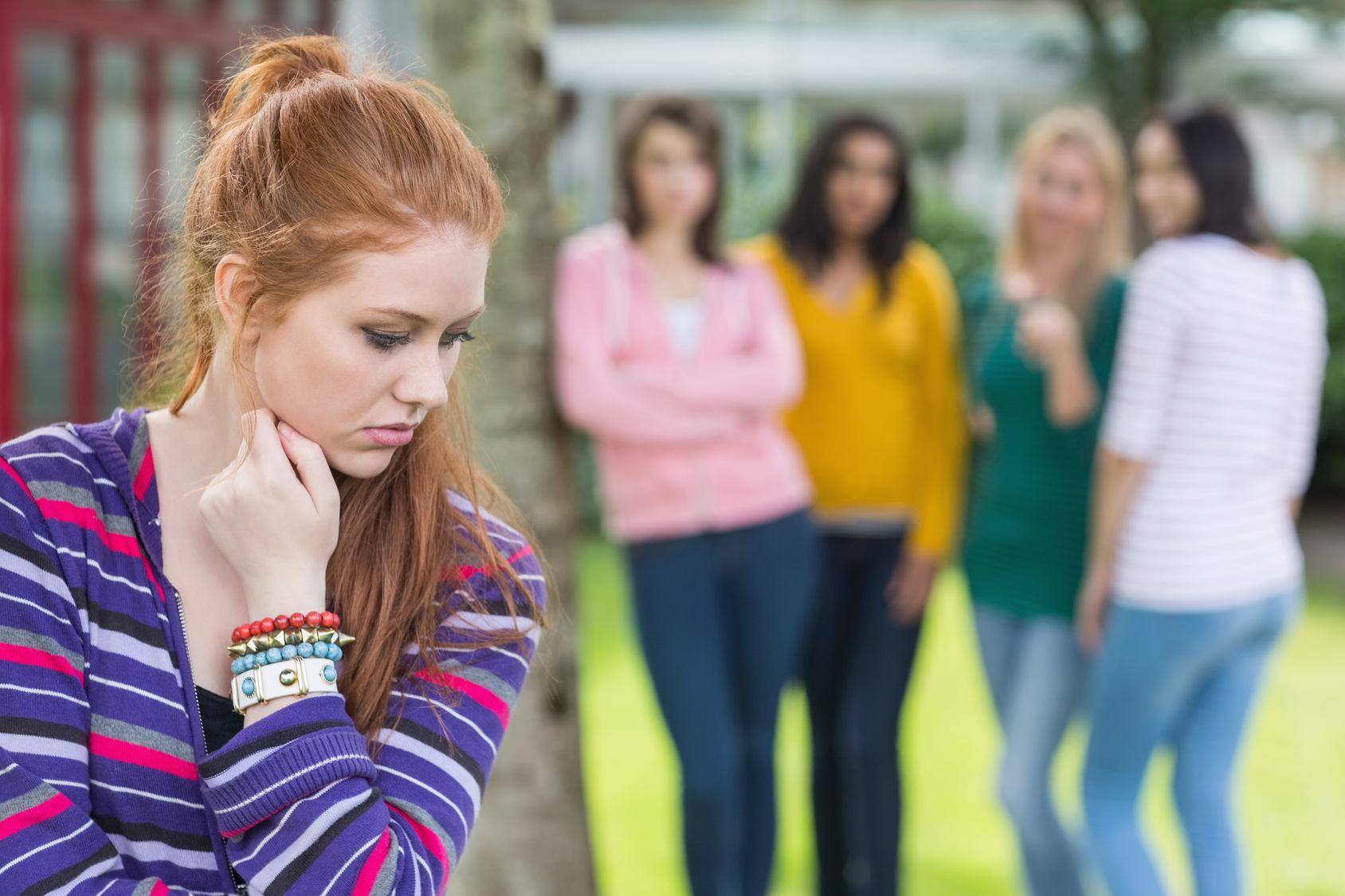 Female student being bullied by other group of students