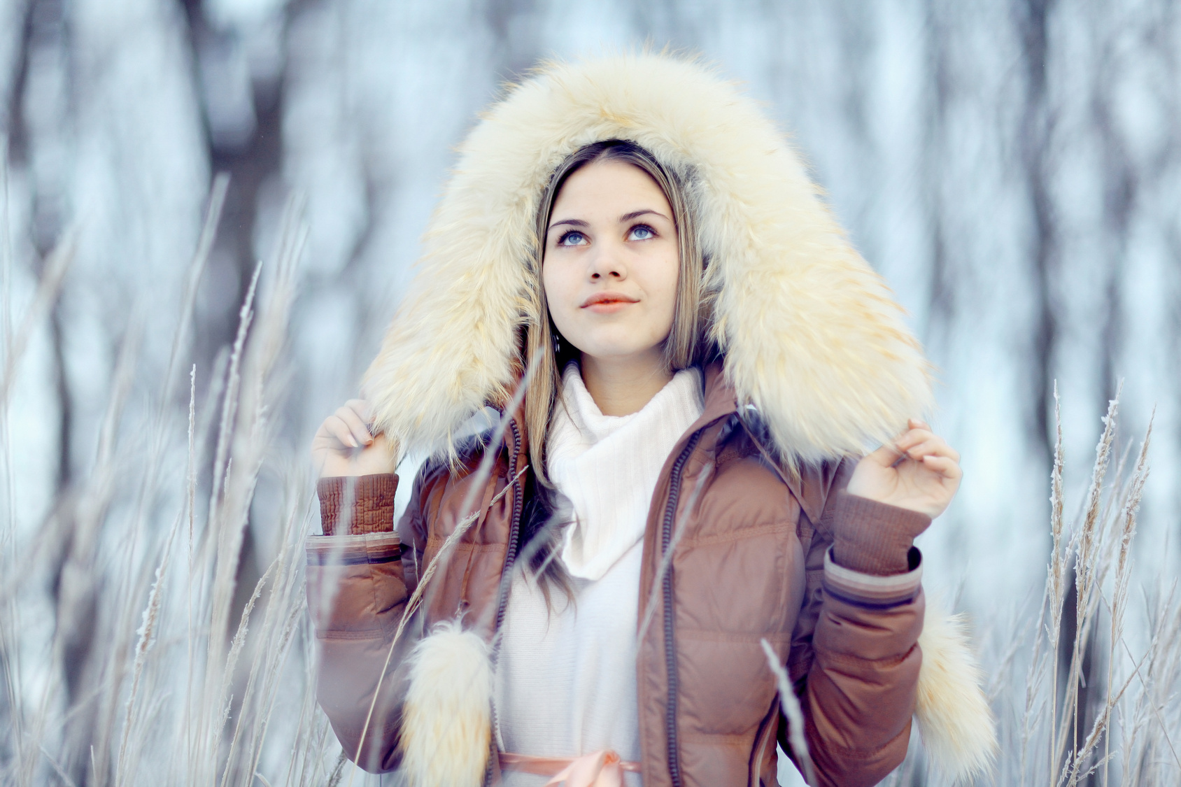 young woman in winter jacket with fur hood