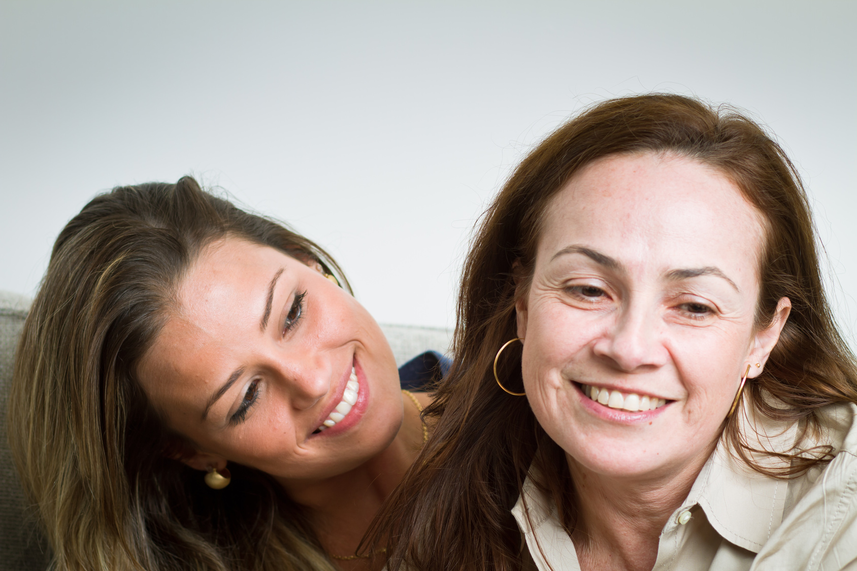 Beautiful brazilian mother and daughter indoors portrait