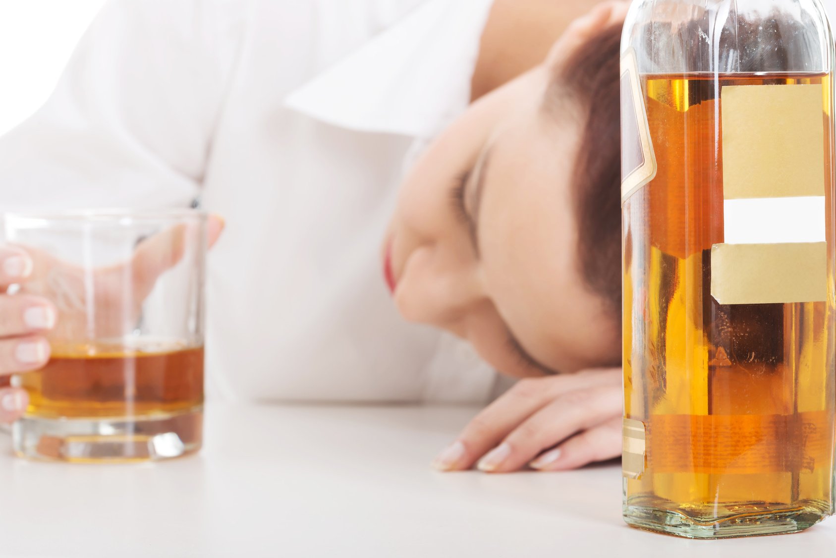 Alone young businesswoman drinking alcohol