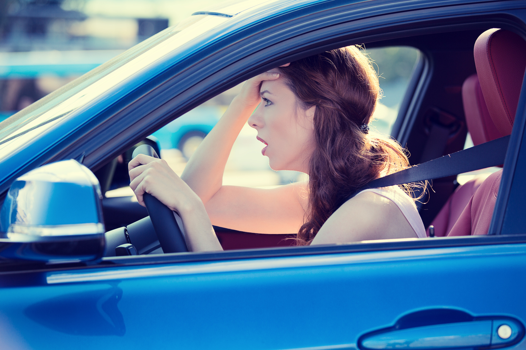 displeased stressed female car driver driving in heavy traffic