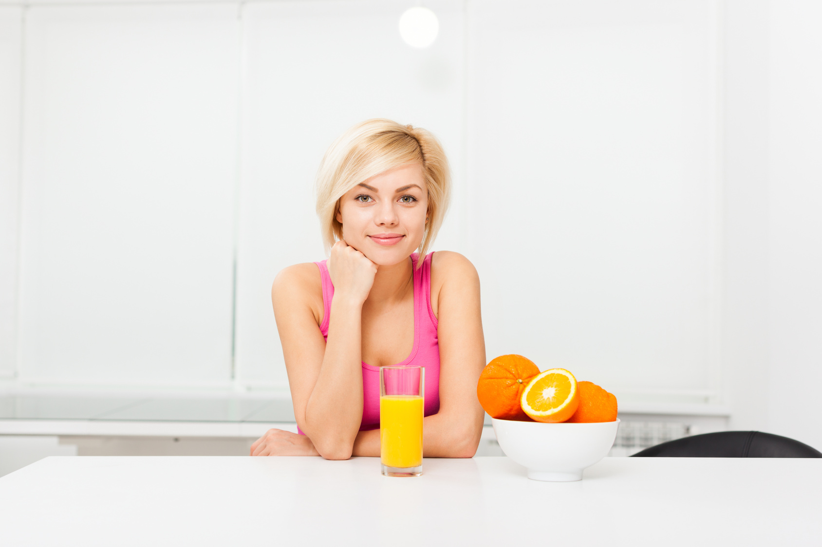 woman orange juice drink glass in her kitchen