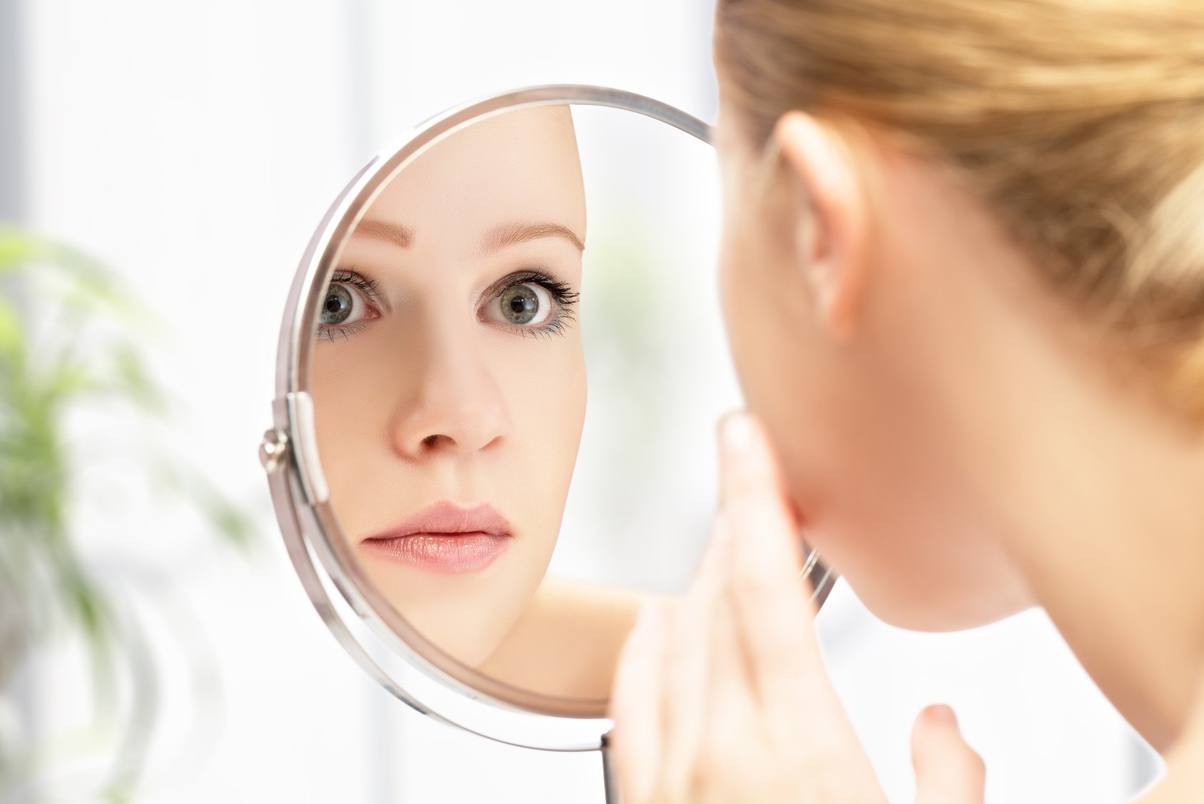 young beautiful healthy woman and reflection in the mirror