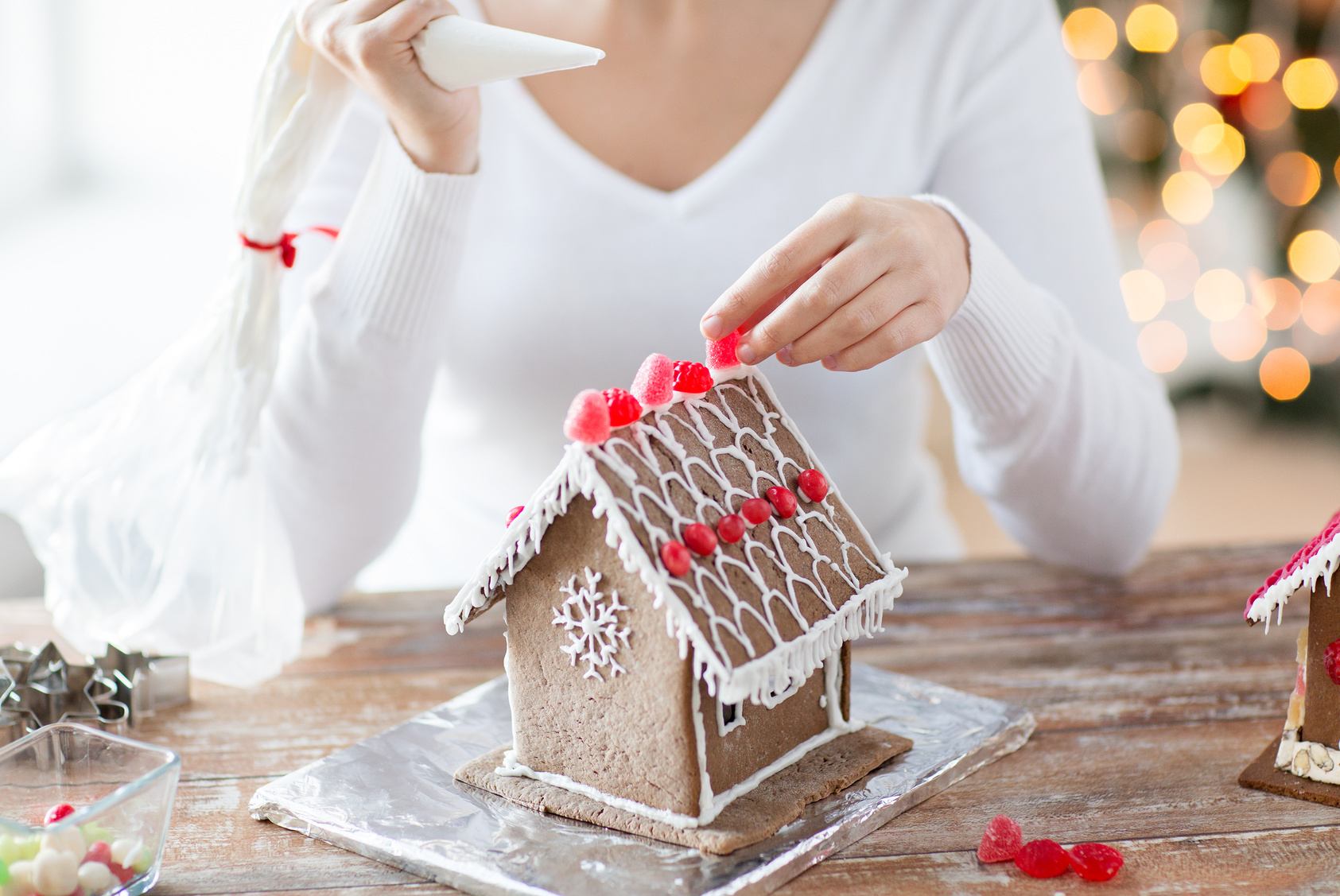 close up of woman making gingerbread houses