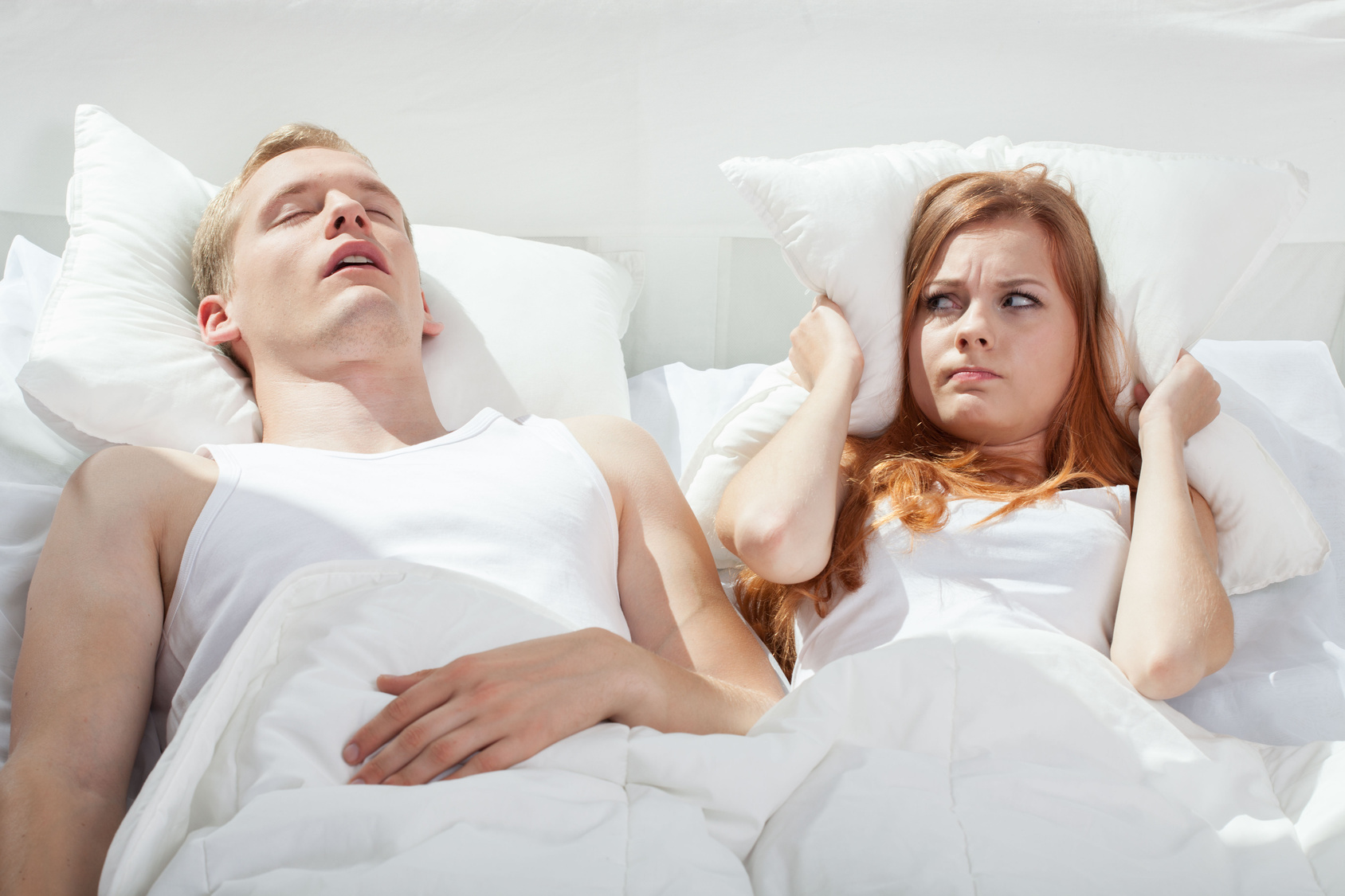 Woman being angry on snoring boyfriend