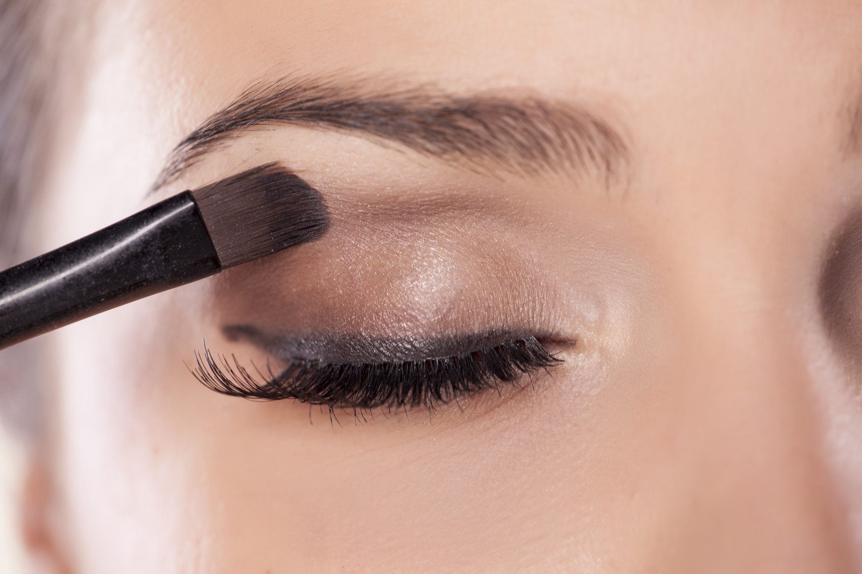 Woman applying eyeshadow