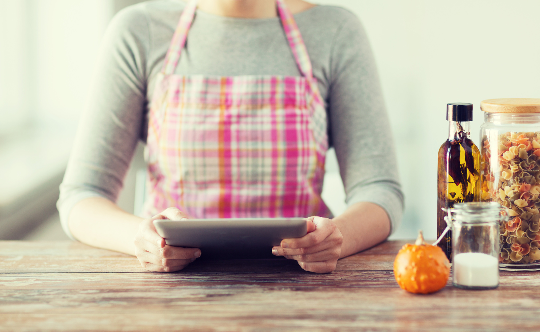 closeup of woman reading recipe from tablet pc
