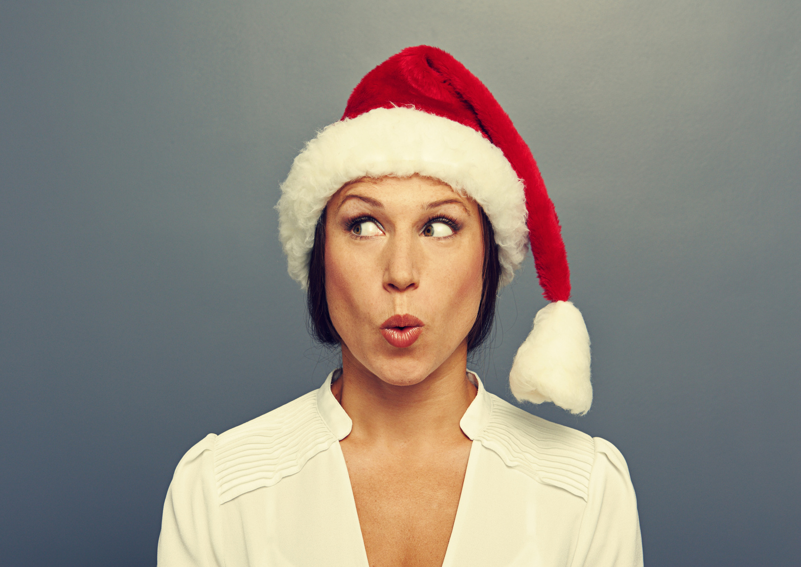 surprised woman in christmas hat
