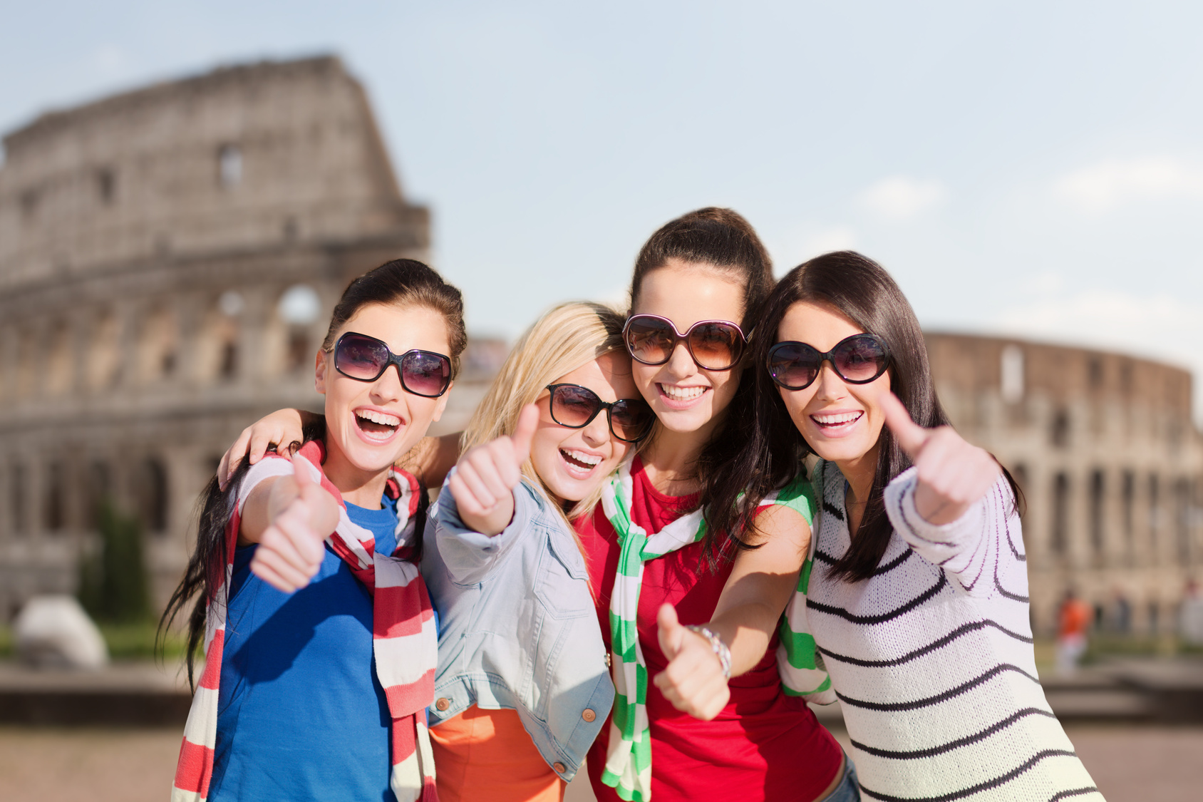 happy teenage girls or women showing thumbs up