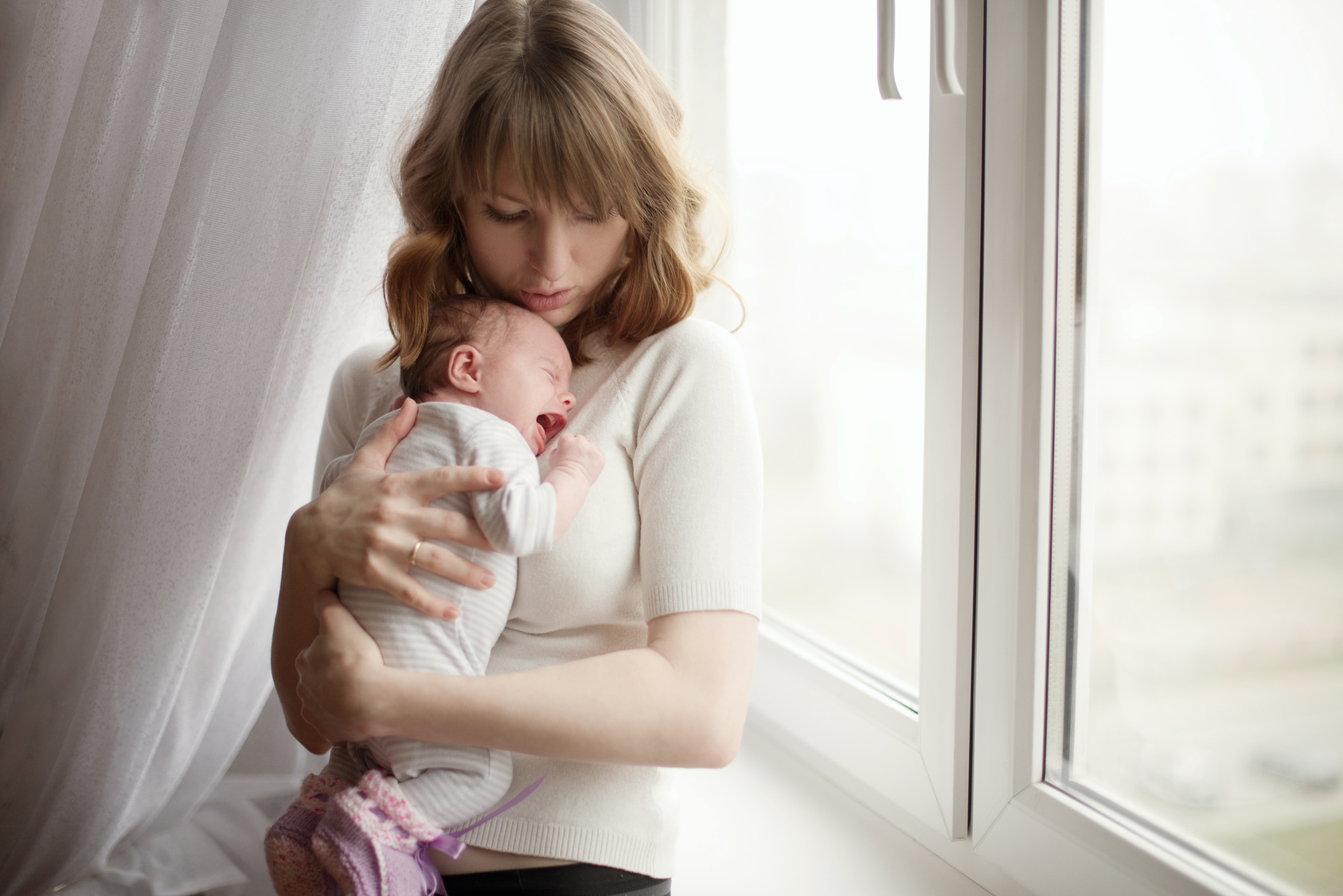 mother with cute little crying baby