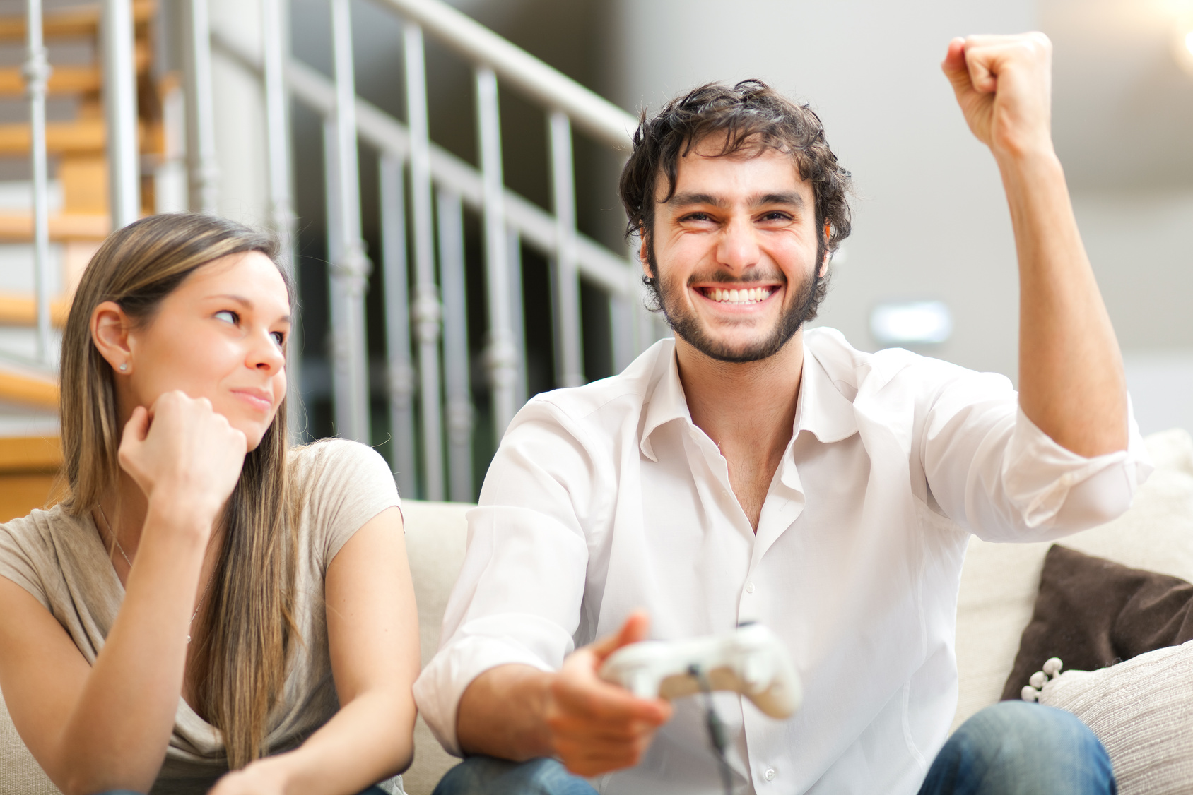 Young couple playing video games in their apartment