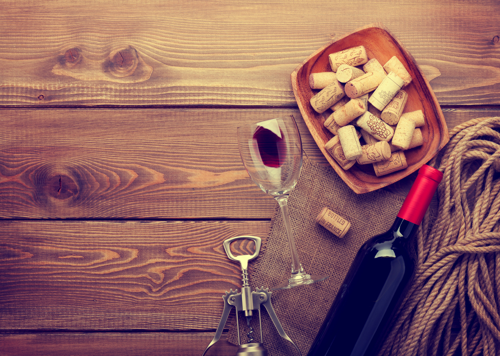 Red wine bottle, glass and corkscrew