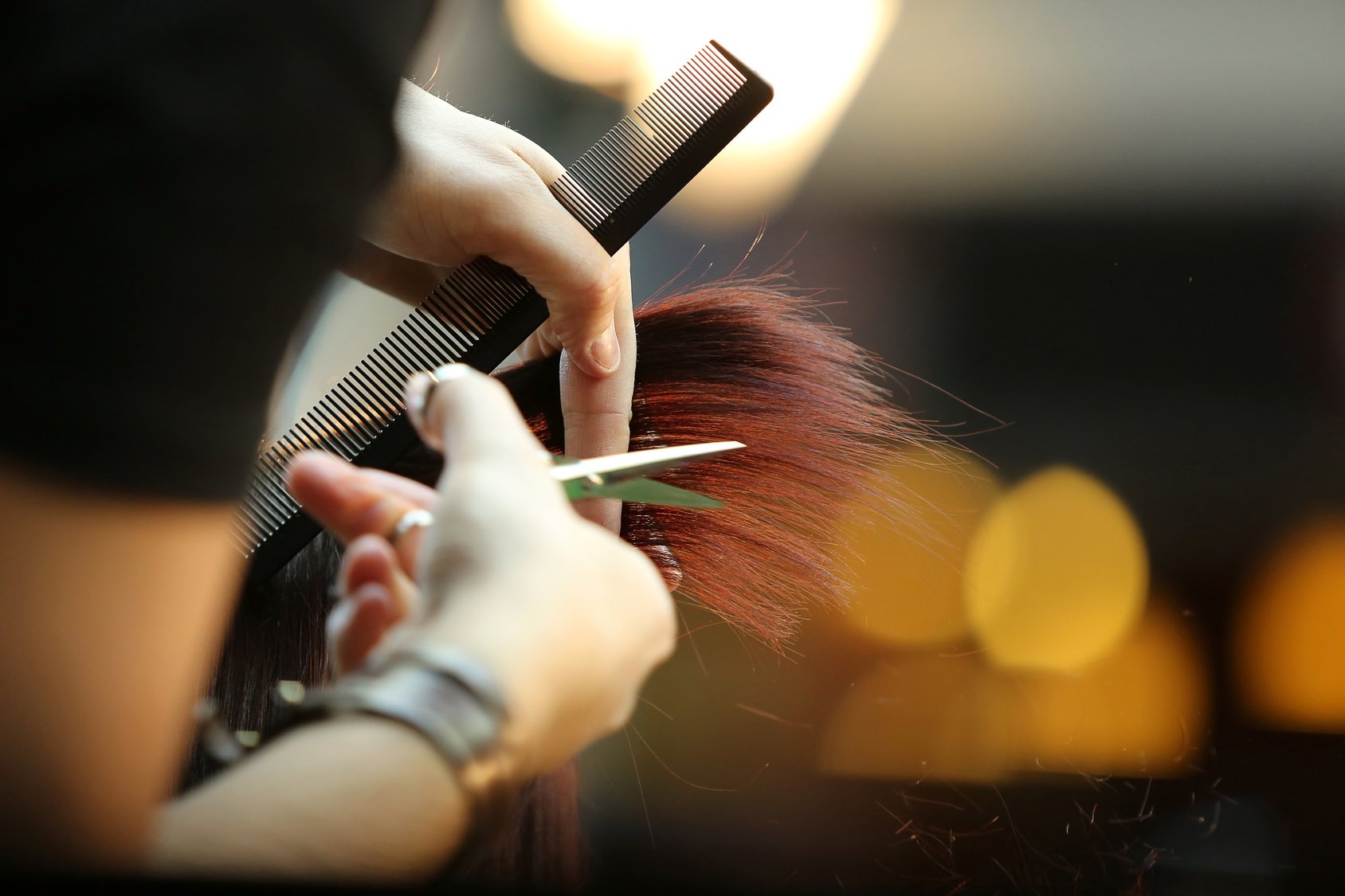 Barber cutting brown hair