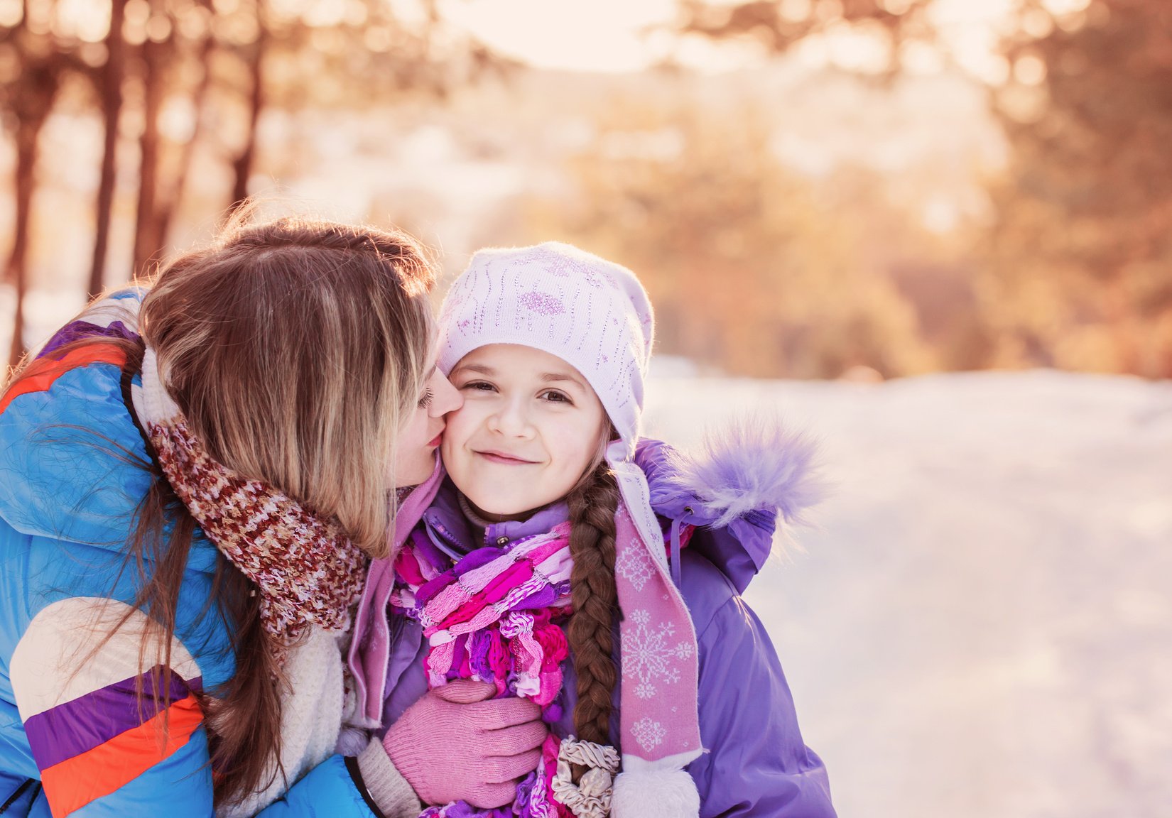 Happy family playing in winter outdoors