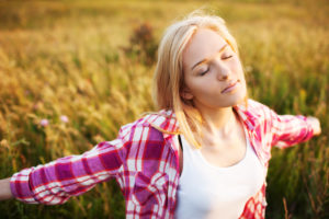 Happy beautiful woman with closed eyes