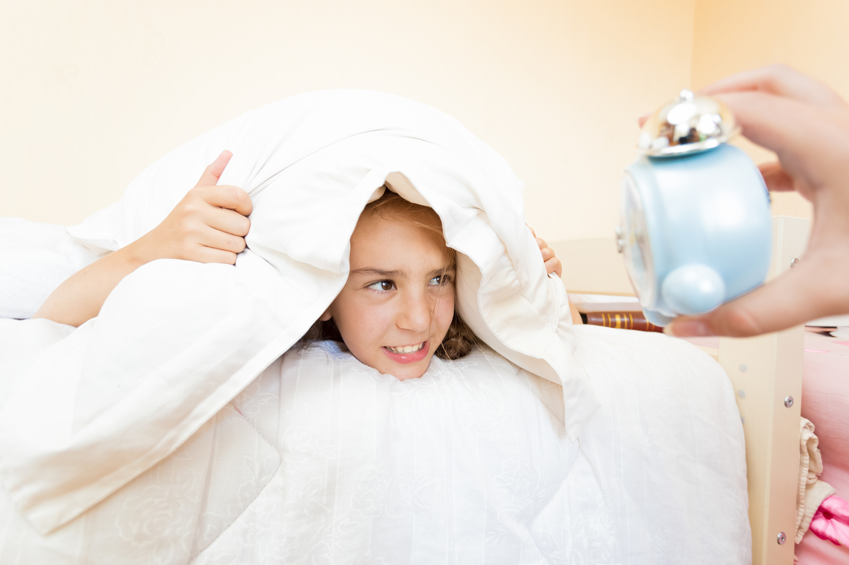little girl being was awakened by alarm clock