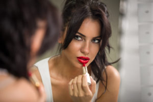 woman applying lipstick